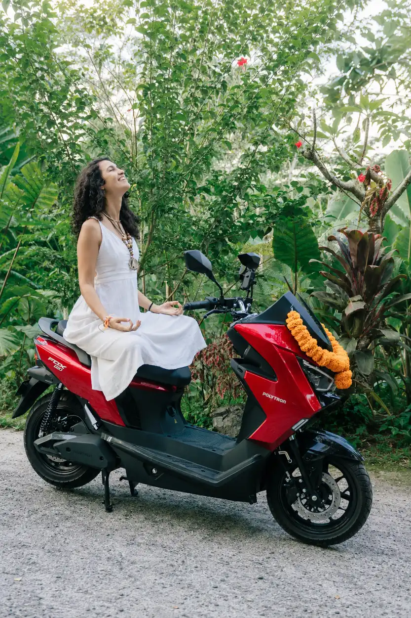Rider sitting calmly on a parked red electric motorbike